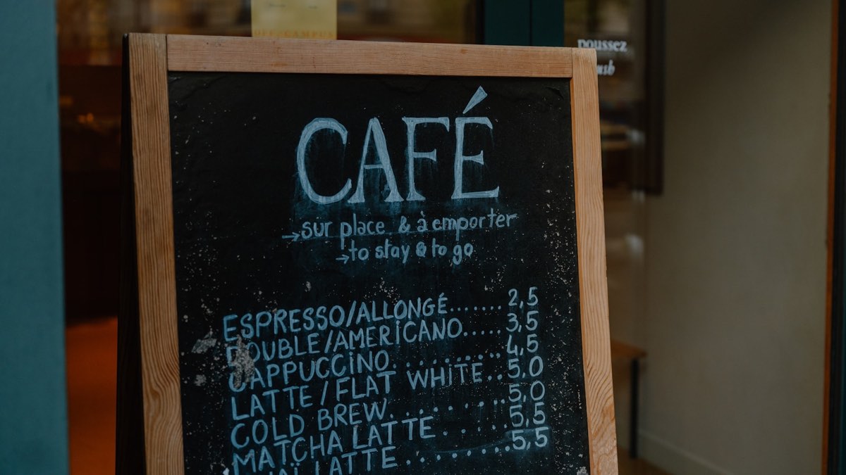 A café chalkboard menu with short drink names and prices without a currency sign